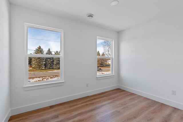 unfurnished room with light hardwood / wood-style flooring