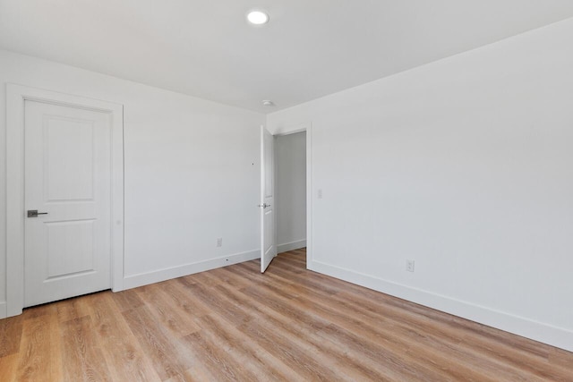 empty room with light hardwood / wood-style flooring