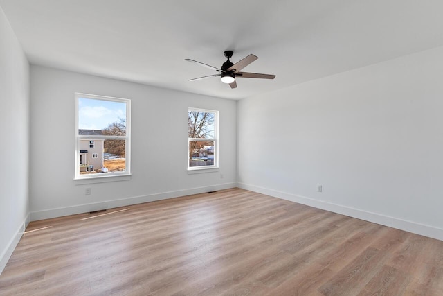 empty room featuring ceiling fan and light hardwood / wood-style flooring