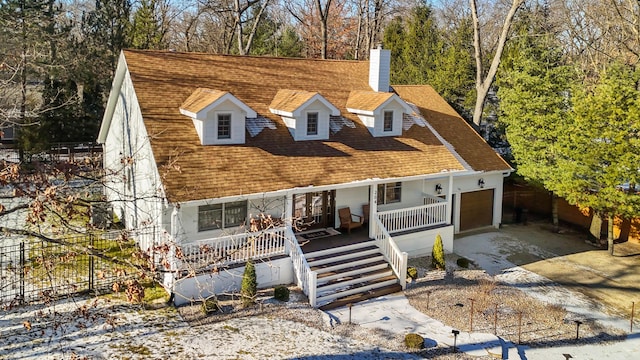 view of front of home featuring covered porch and a garage