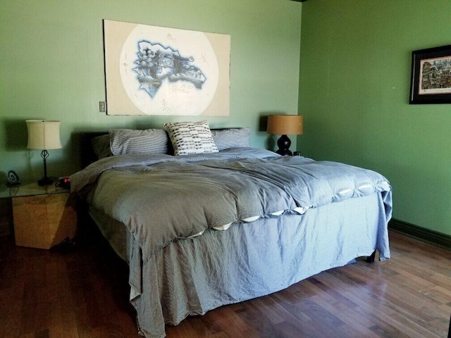 bedroom featuring dark wood-type flooring