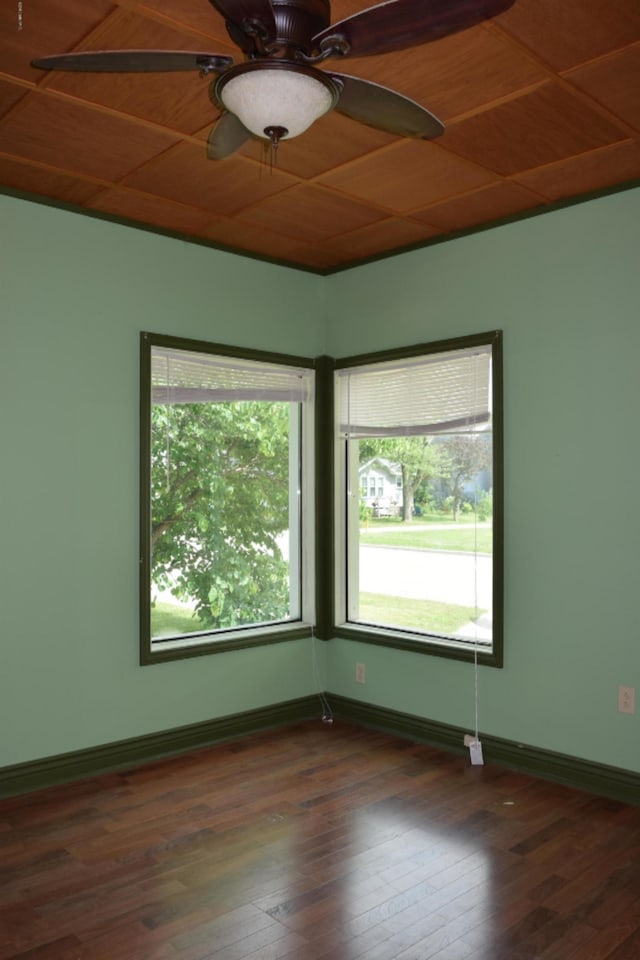 spare room with ceiling fan, plenty of natural light, wood ceiling, and dark hardwood / wood-style floors