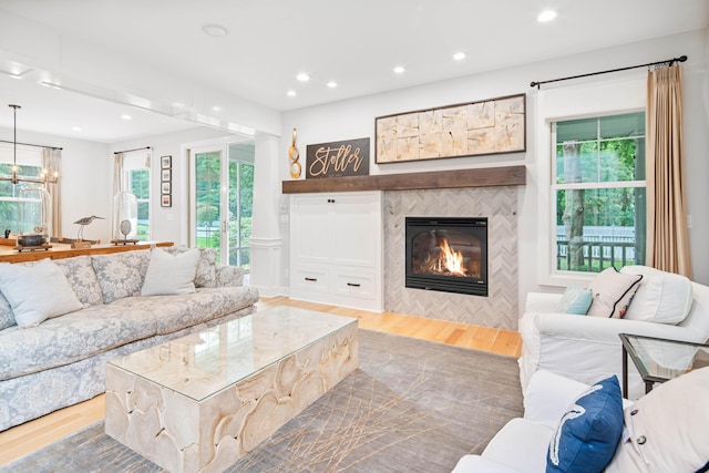 living room featuring a fireplace and light wood-type flooring