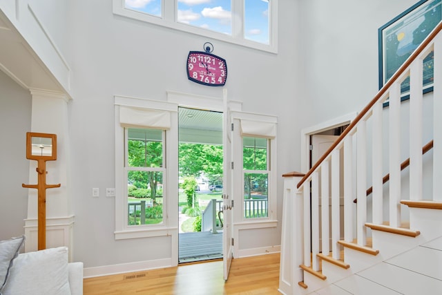 foyer featuring a high ceiling and light hardwood / wood-style flooring