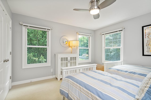 carpeted bedroom featuring a closet and ceiling fan