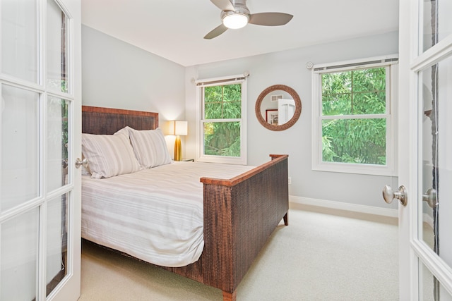 carpeted bedroom featuring french doors and ceiling fan