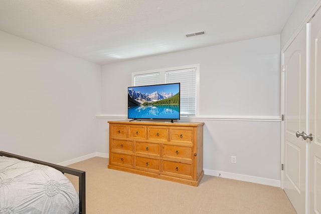 bedroom with light colored carpet