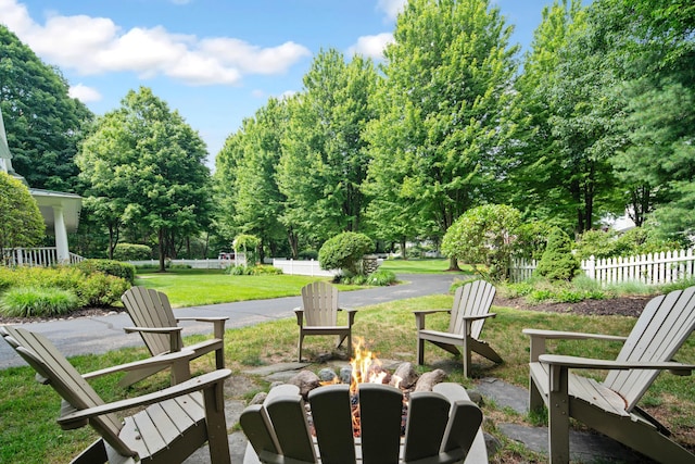 exterior space featuring a lawn and an outdoor fire pit