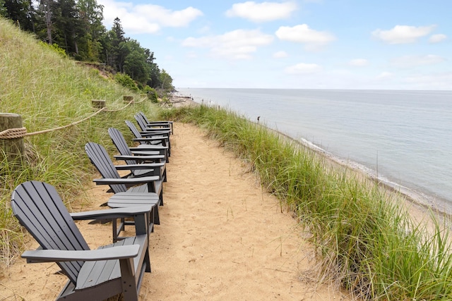 view of home's community with a water view and a view of the beach