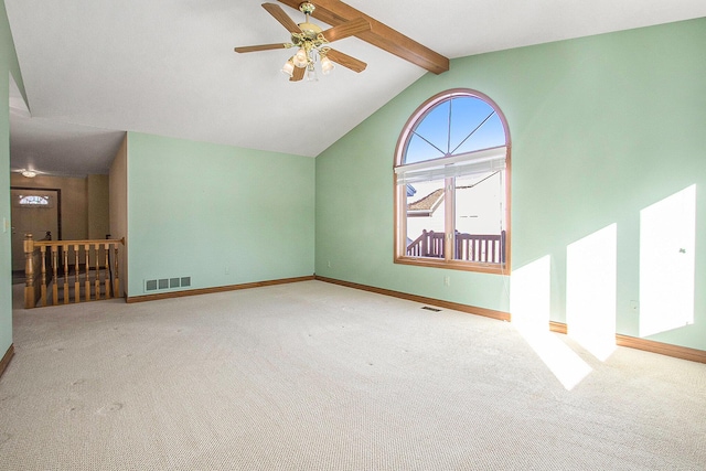 unfurnished living room featuring lofted ceiling with beams, light colored carpet, and ceiling fan