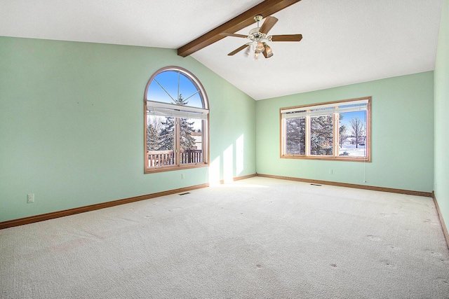 spare room with vaulted ceiling with beams, light colored carpet, and ceiling fan