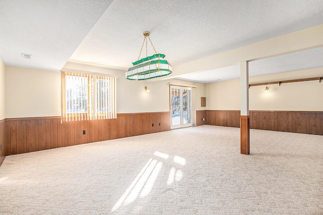 spare room with a textured ceiling and carpet