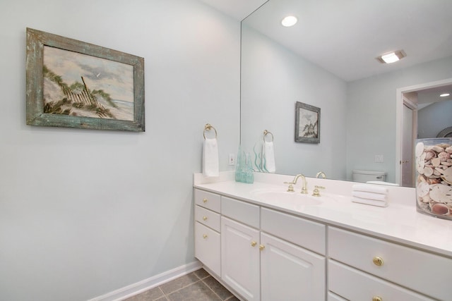 bathroom with tile patterned flooring, vanity, and toilet