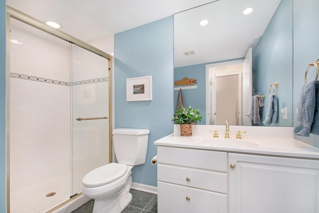 bathroom featuring tile patterned flooring, vanity, toilet, and a shower with shower door