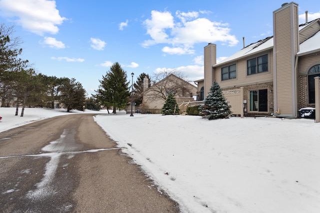 yard covered in snow featuring a garage