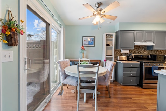 dining area featuring ceiling fan and light wood-type flooring