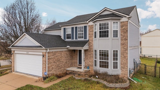 view of front of house featuring a garage and a front lawn