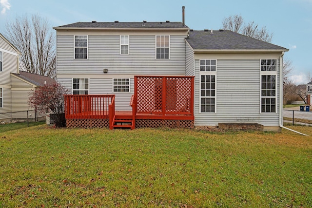 rear view of property with a yard and a deck