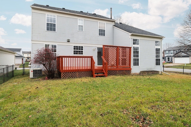 rear view of property featuring a deck, central AC unit, and a lawn