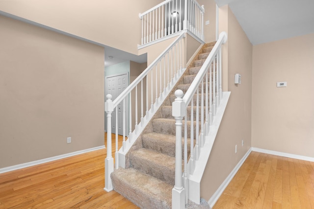 stairway with hardwood / wood-style floors