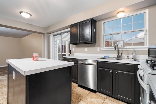 kitchen featuring sink, a kitchen island, a healthy amount of sunlight, and appliances with stainless steel finishes