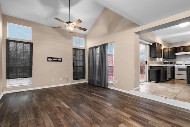 unfurnished living room featuring ceiling fan, high vaulted ceiling, and light hardwood / wood-style floors