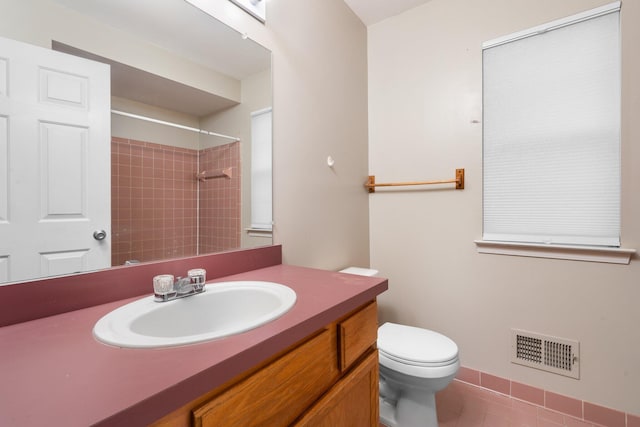 bathroom with tile patterned flooring, vanity, and toilet