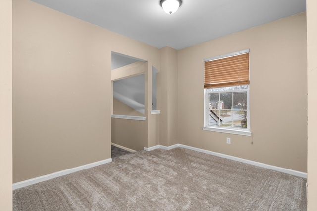 spare room featuring light colored carpet