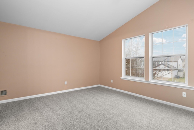 unfurnished room featuring carpet flooring and lofted ceiling