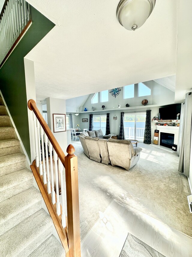 carpeted living room featuring vaulted ceiling