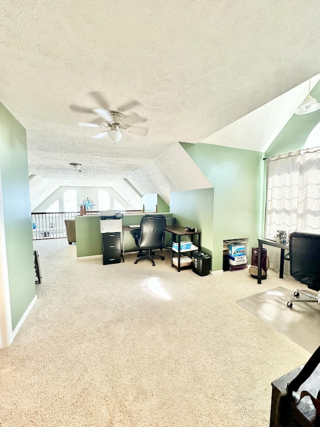 office area with a textured ceiling, carpet floors, ceiling fan, and lofted ceiling