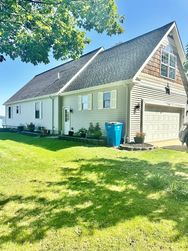 view of front of property with a garage, a front yard, and central AC