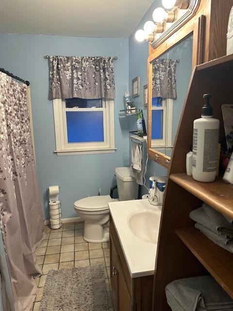 bathroom with tile patterned floors, vanity, and toilet