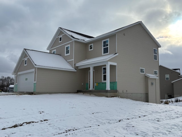 exterior space with covered porch and a garage