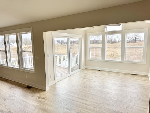 unfurnished sunroom featuring visible vents