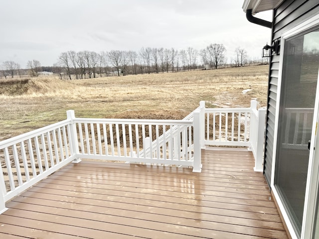 wooden deck with a rural view