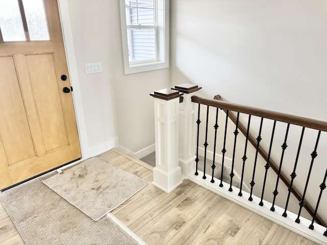 foyer with baseboards and wood finished floors