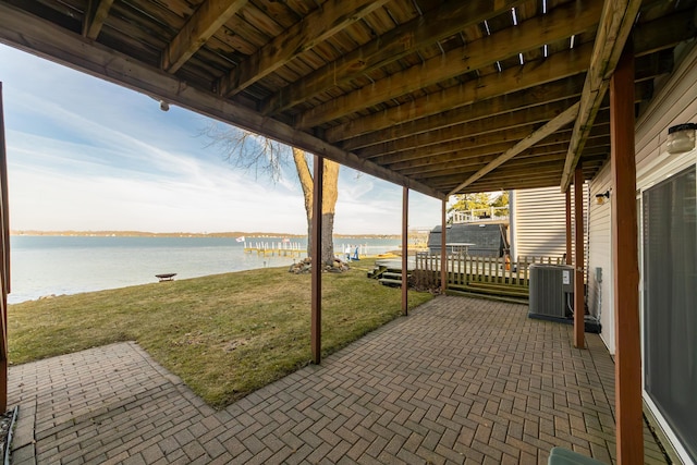 view of patio with a water view and central AC