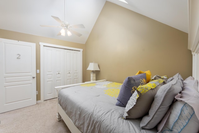 bedroom with light carpet, lofted ceiling, a closet, and ceiling fan