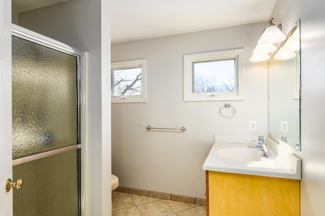 bathroom with a shower stall, baseboards, toilet, tile patterned floors, and vanity