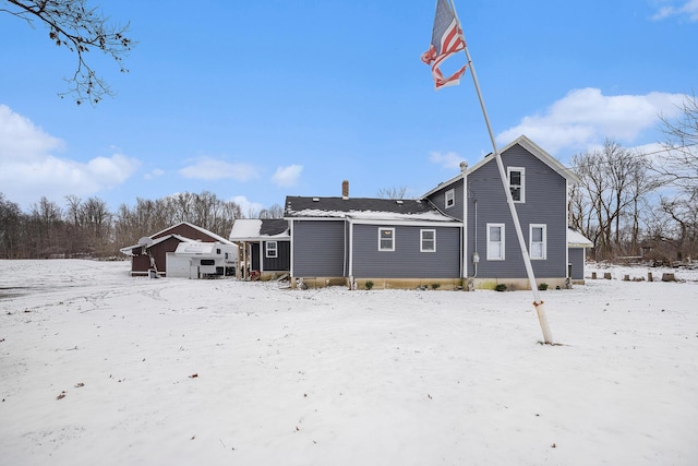 view of snow covered rear of property