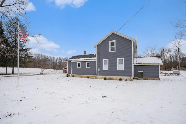 view of snow covered rear of property