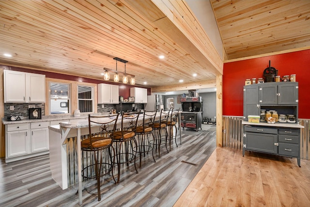 kitchen with white cabinetry, hanging light fixtures, gray cabinetry, and wood ceiling