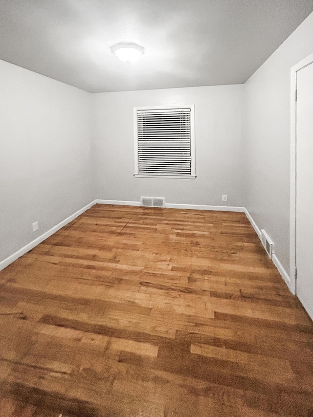 spare room with hardwood / wood-style flooring