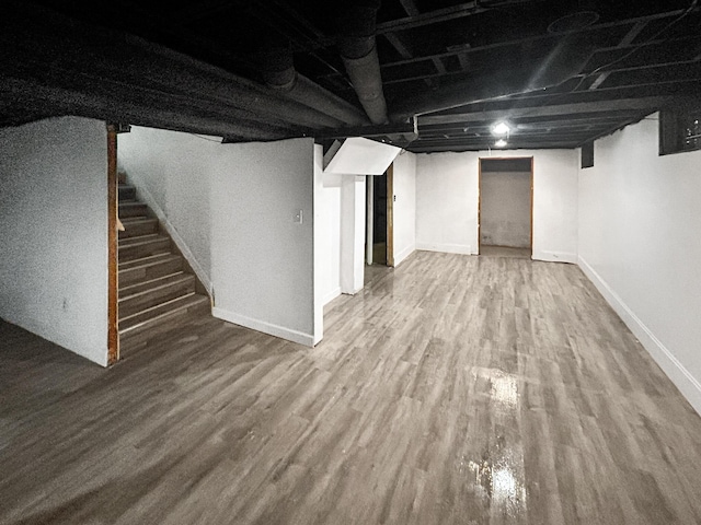 basement with hardwood / wood-style floors