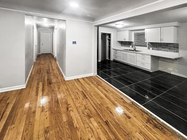 kitchen with white cabinets, dark hardwood / wood-style floors, sink, and tasteful backsplash