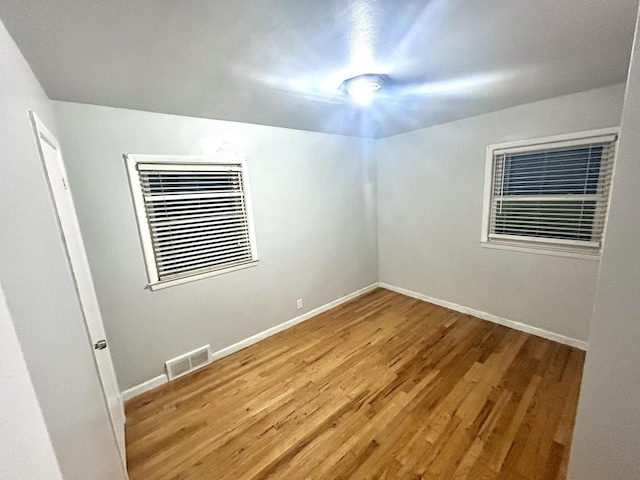 empty room with light hardwood / wood-style floors