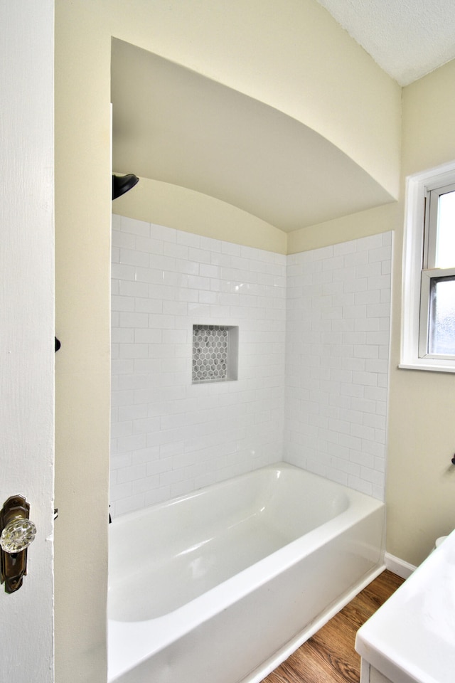 bathroom with shower / bathing tub combination and wood-type flooring