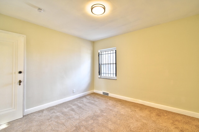 unfurnished room with light carpet