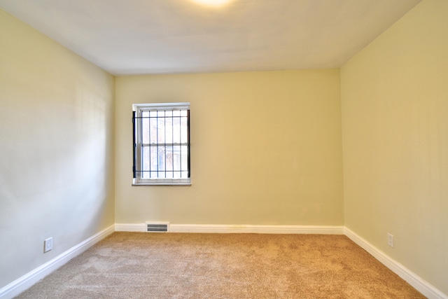 unfurnished room featuring light colored carpet